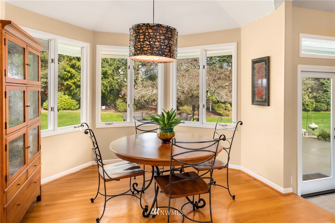 21731 35th Avenue Southeast Bothell, WA 98021 - Photo 10 of 36 a dining room with furniture a chandelier and wooden floor