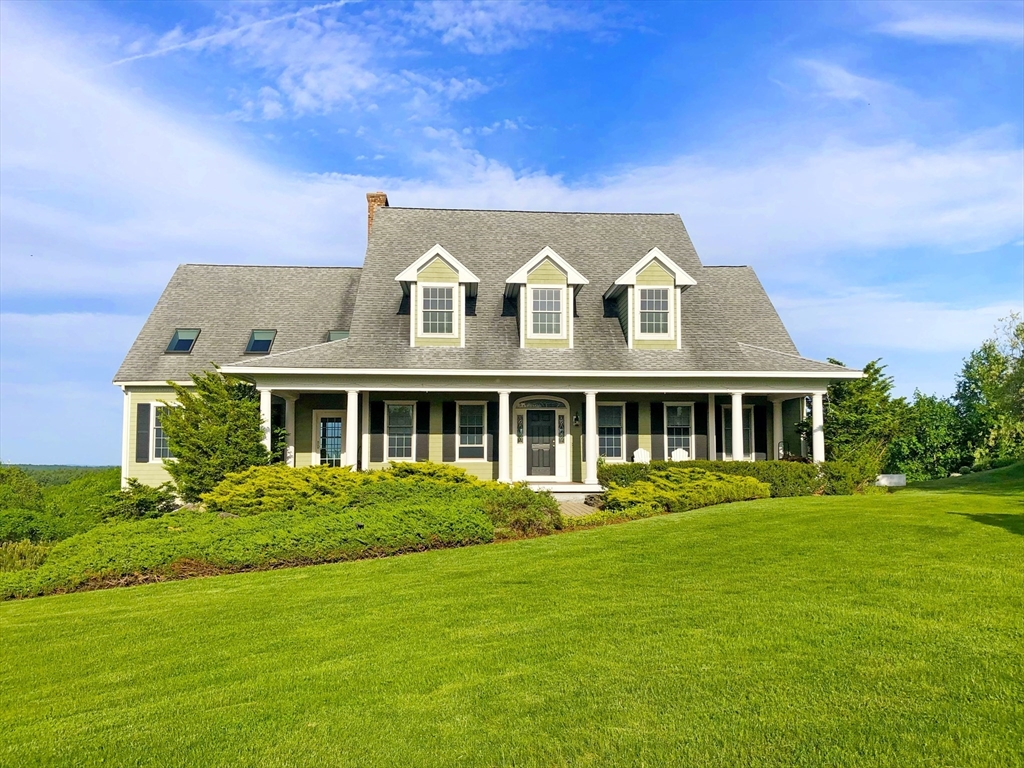 63 Skyfields Drive Groton, MA 01450 - Photo 1 of 40 a front view of a house with a garden