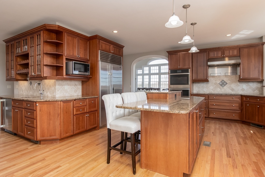 63 Skyfields Drive Groton, MA 01450 - Photo 11 of 40 a kitchen with granite countertop a sink cabinets and window