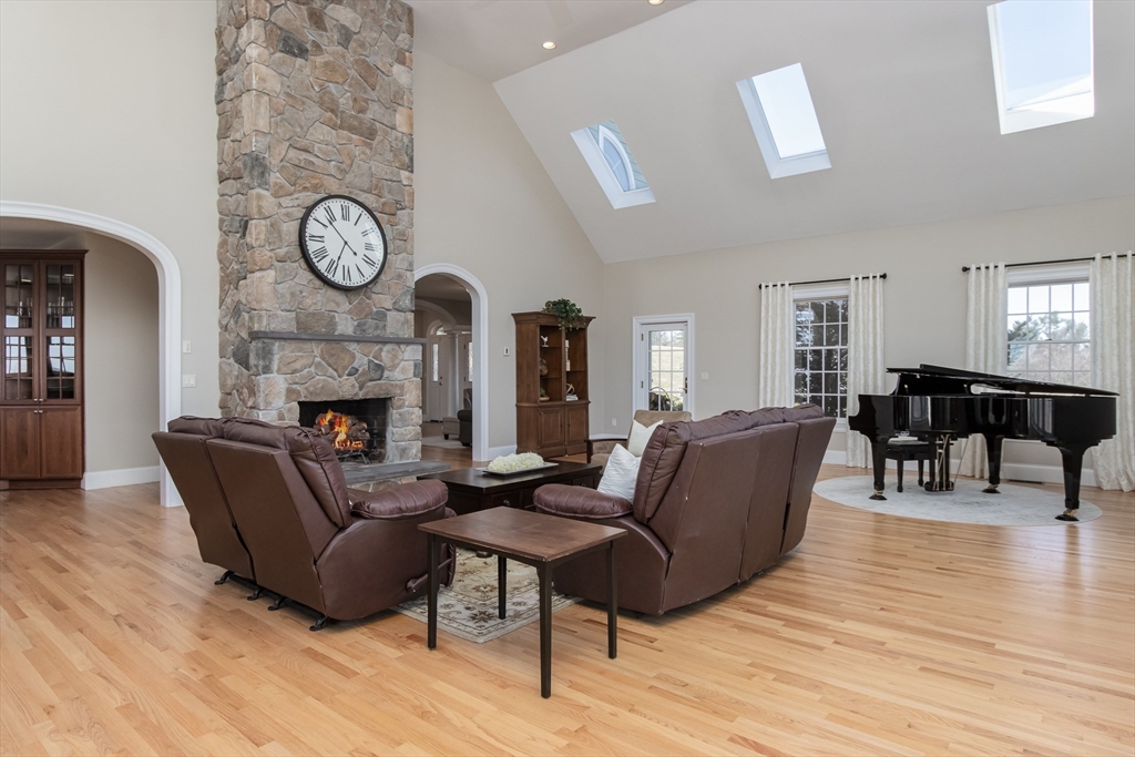 63 Skyfields Drive Groton, MA 01450 - Photo 14 of 40 a living room with furniture a fireplace and wooden floor