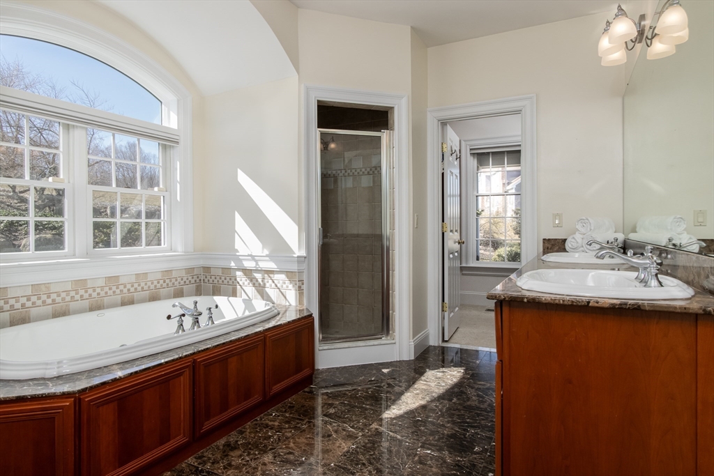 63 Skyfields Drive Groton, MA 01450 - Photo 16 of 40 a spacious bathroom with a granite countertop sink and a large mirror