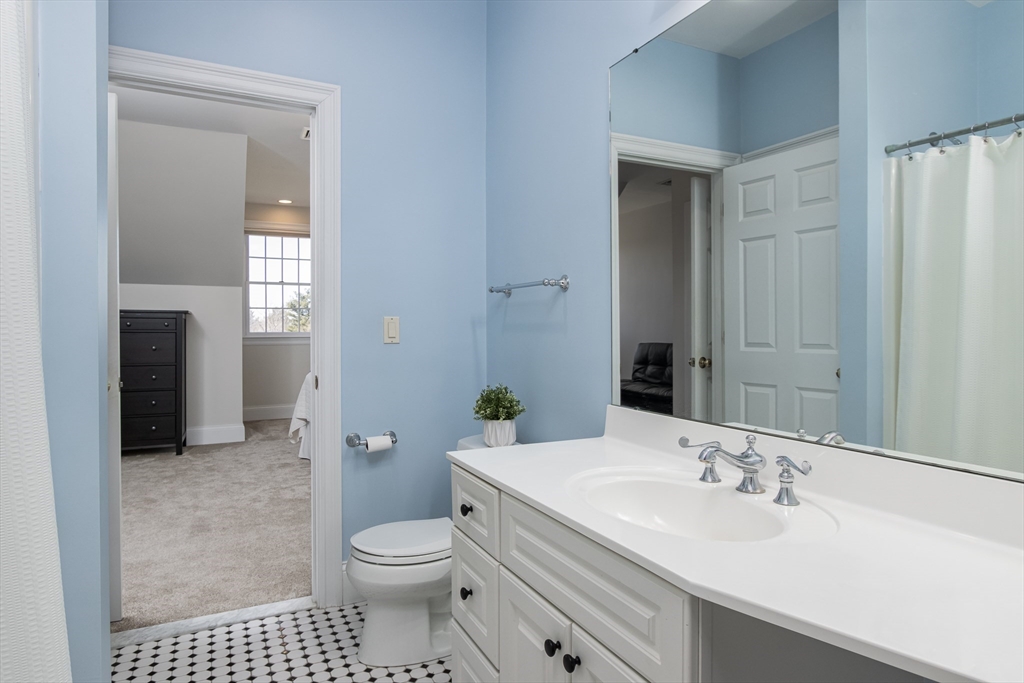 63 Skyfields Drive Groton, MA 01450 - Photo 22 of 40 a bathroom with a sink a toilet and shower