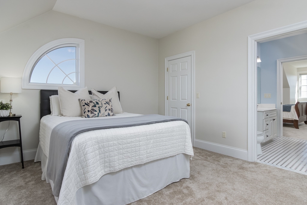 63 Skyfields Drive Groton, MA 01450 - Photo 23 of 40 a bedroom with a bed and a lamp