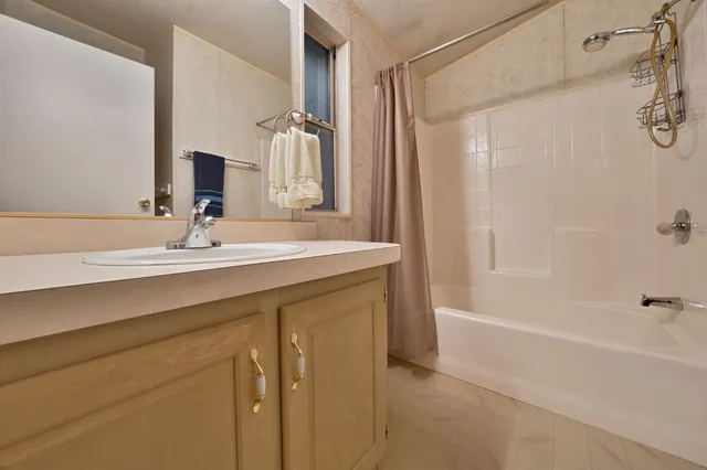 a bathroom with a sink double vanity and a bathtub
