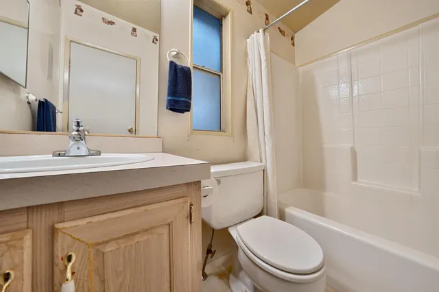 a bathroom with a sink toilet vanity and shower