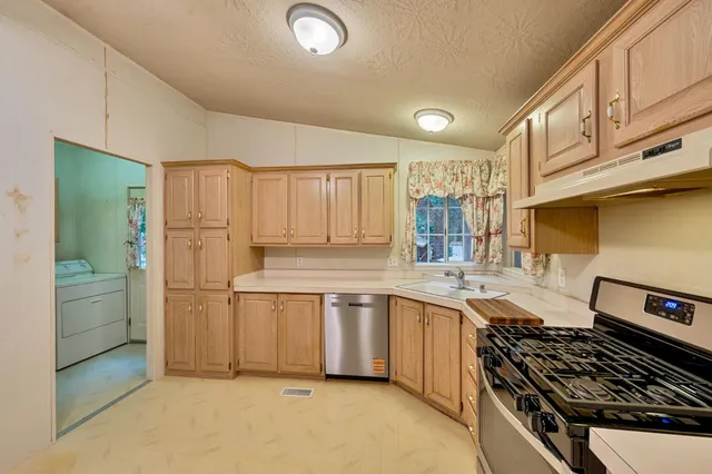 a kitchen with a stove and a refrigerator