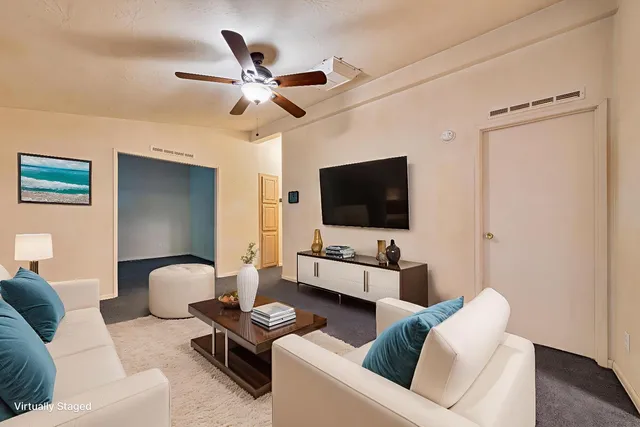 a living room with furniture and a flat screen tv