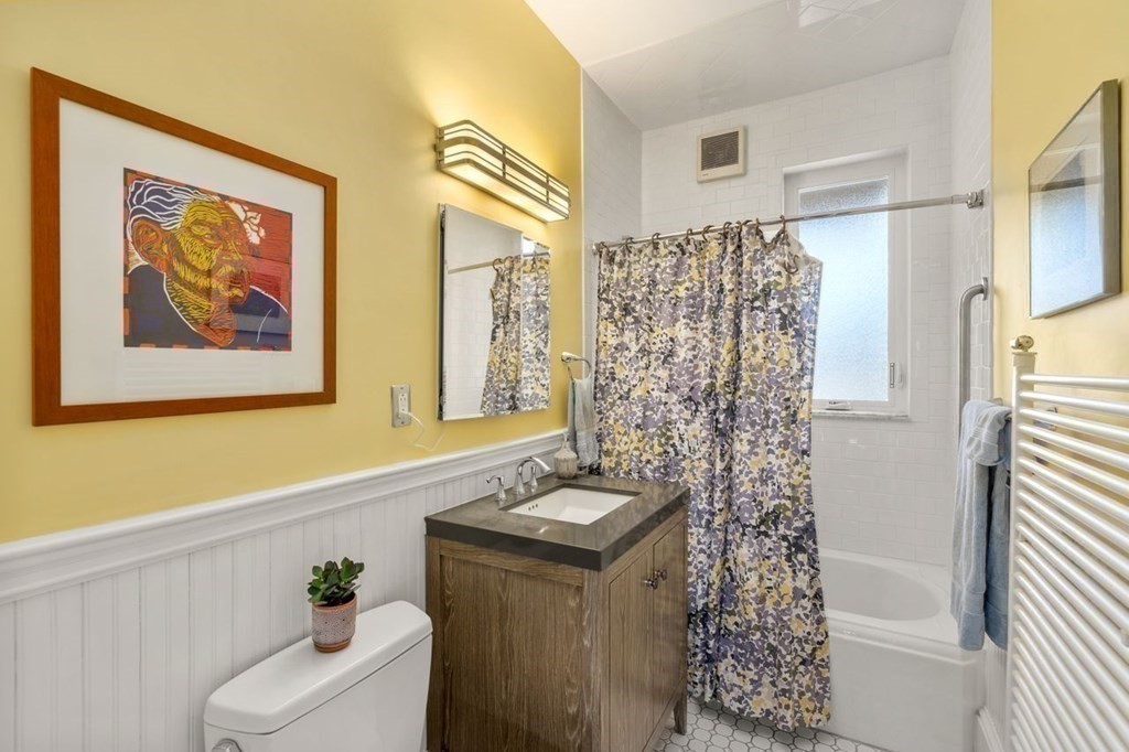 10 Kilsyth Road, Unit 2 Brookline, MA 02445 - Photo 15 of 21 a bathroom with a sink a toilet and shower curtain