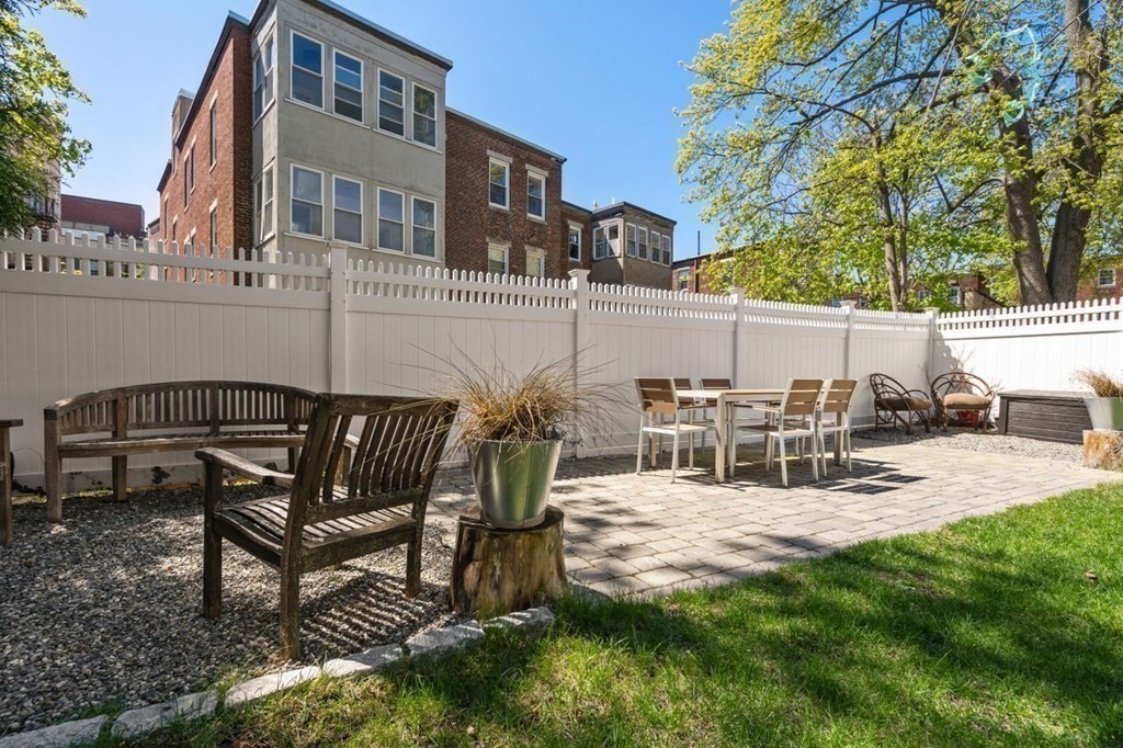 10 Kilsyth Road, Unit 2 Brookline, MA 02445 - Photo 19 of 21 a view of a patio with table and chairs with plants and trees