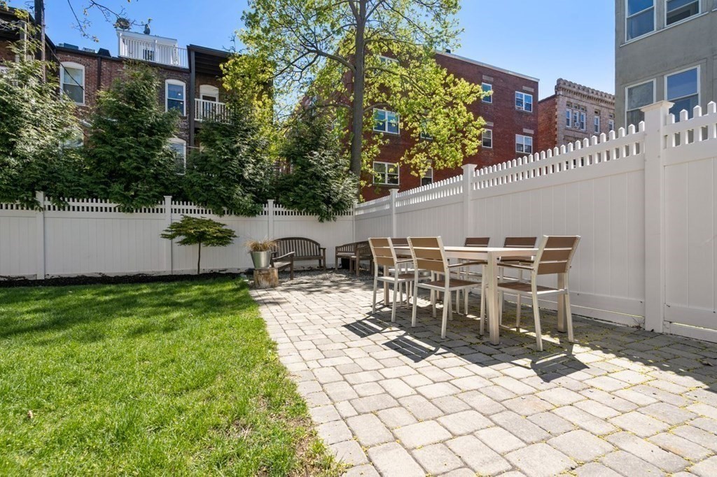 10 Kilsyth Road, Unit 2 Brookline, MA 02445 - Photo 20 of 21 a patio with table and chairs and potted plants