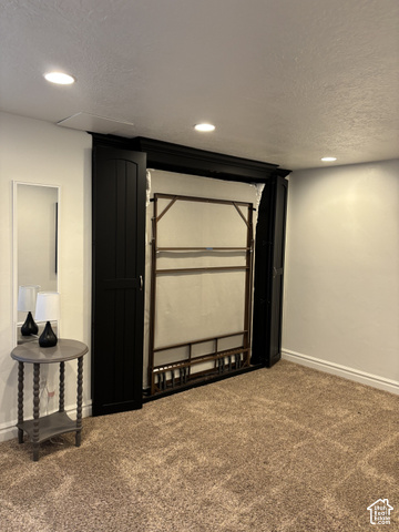 11689 South Shadow View Lane Draper, UT 84020 - Photo 17 of 25 Recessed lighting illuminates the space, featuring a built-in Murphy bed with dark cabinetry, and neutral-toned carpet flooring
