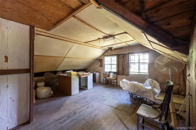 a view of a livingroom with furniture and a window