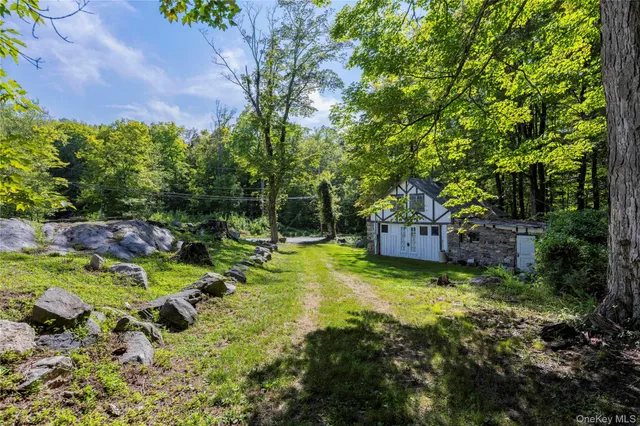 a backyard of a house with a yard and outdoor seating