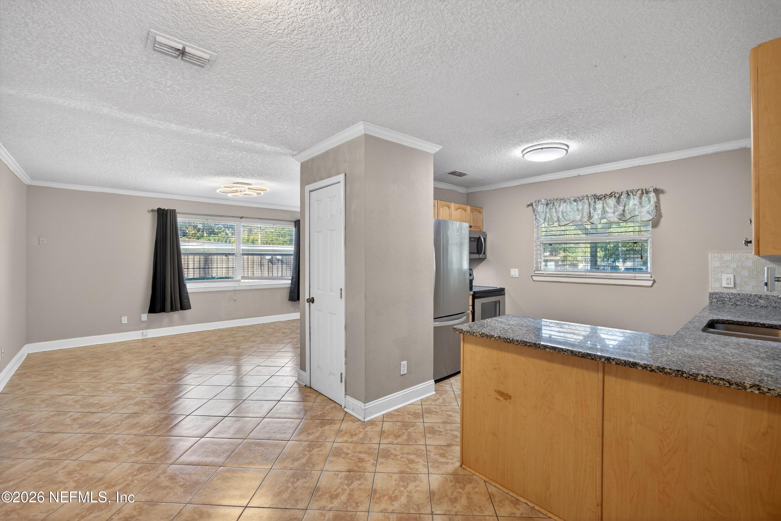 5134 Damascus Road South Jacksonville, FL 32207 - Photo 13 of 41 a view of a kitchen with furniture and a window