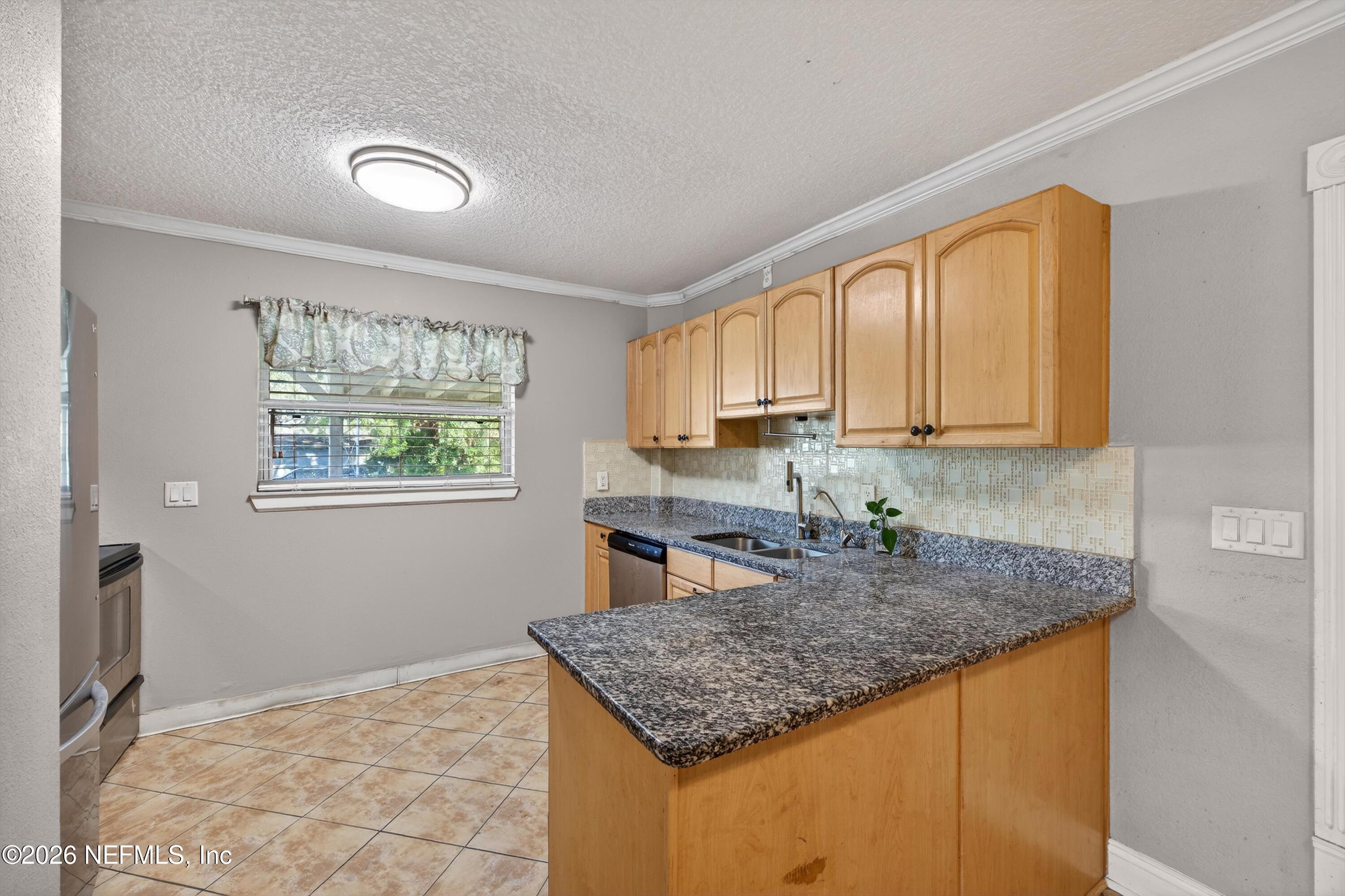 5134 Damascus Road South Jacksonville, FL 32207 - Photo 14 of 41 a kitchen with stainless steel appliances granite countertop a sink stove and cabinets