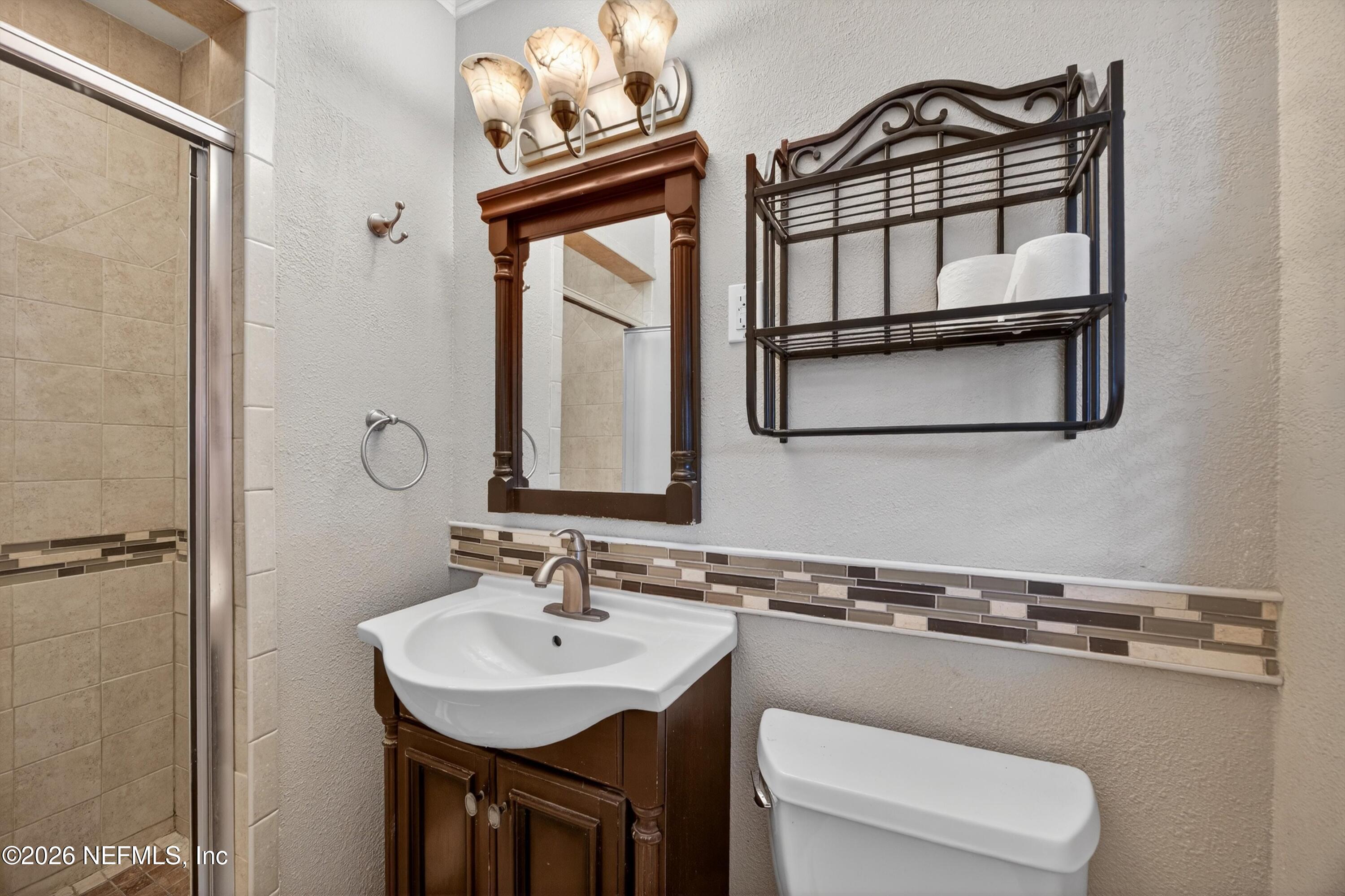 5134 Damascus Road South Jacksonville, FL 32207 - Photo 23 of 41 a bathroom with a sink a toilet and mirror