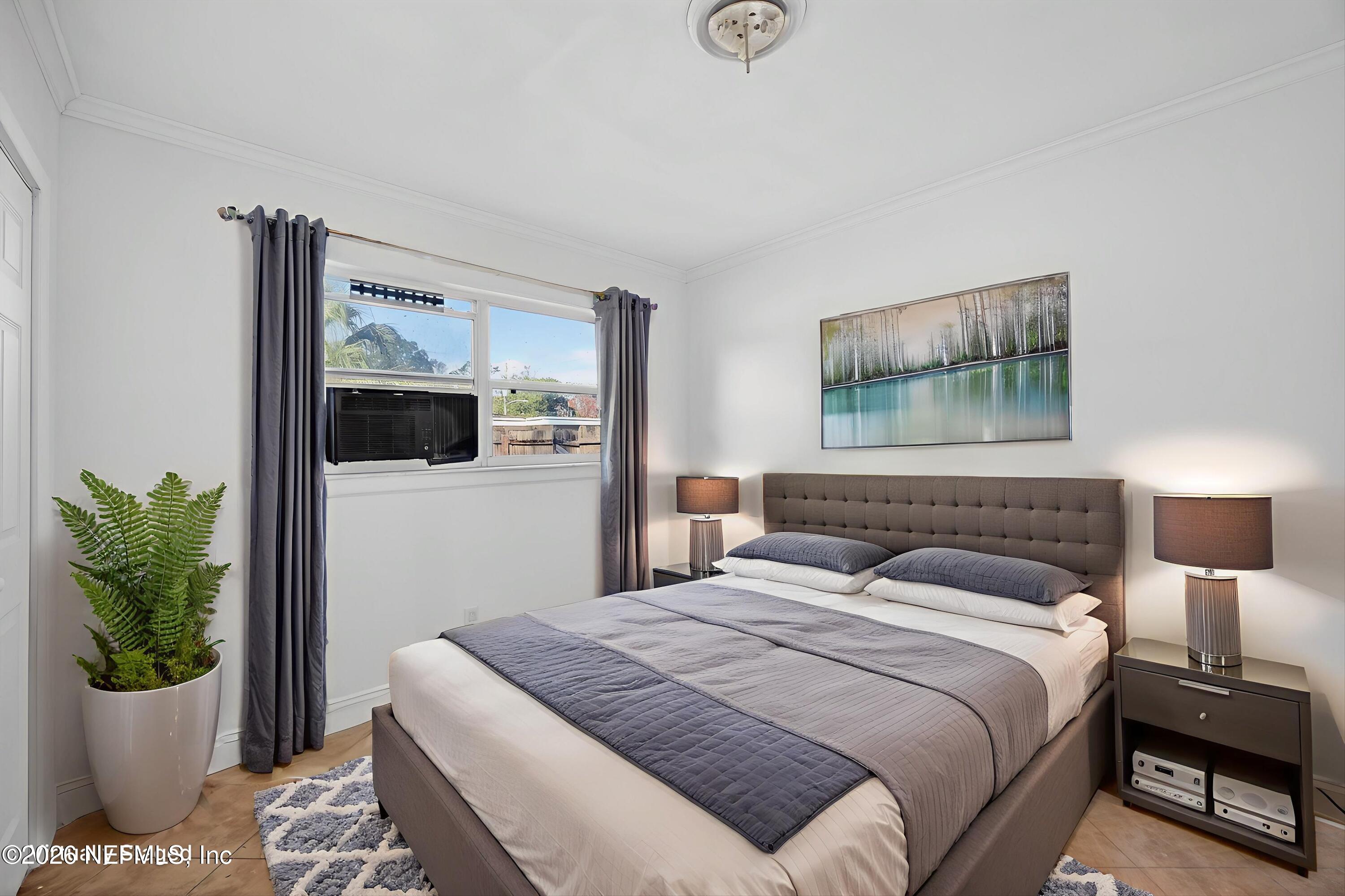 5134 Damascus Road South Jacksonville, FL 32207 - Photo 24 of 41 a bedroom with a bed and a potted plant