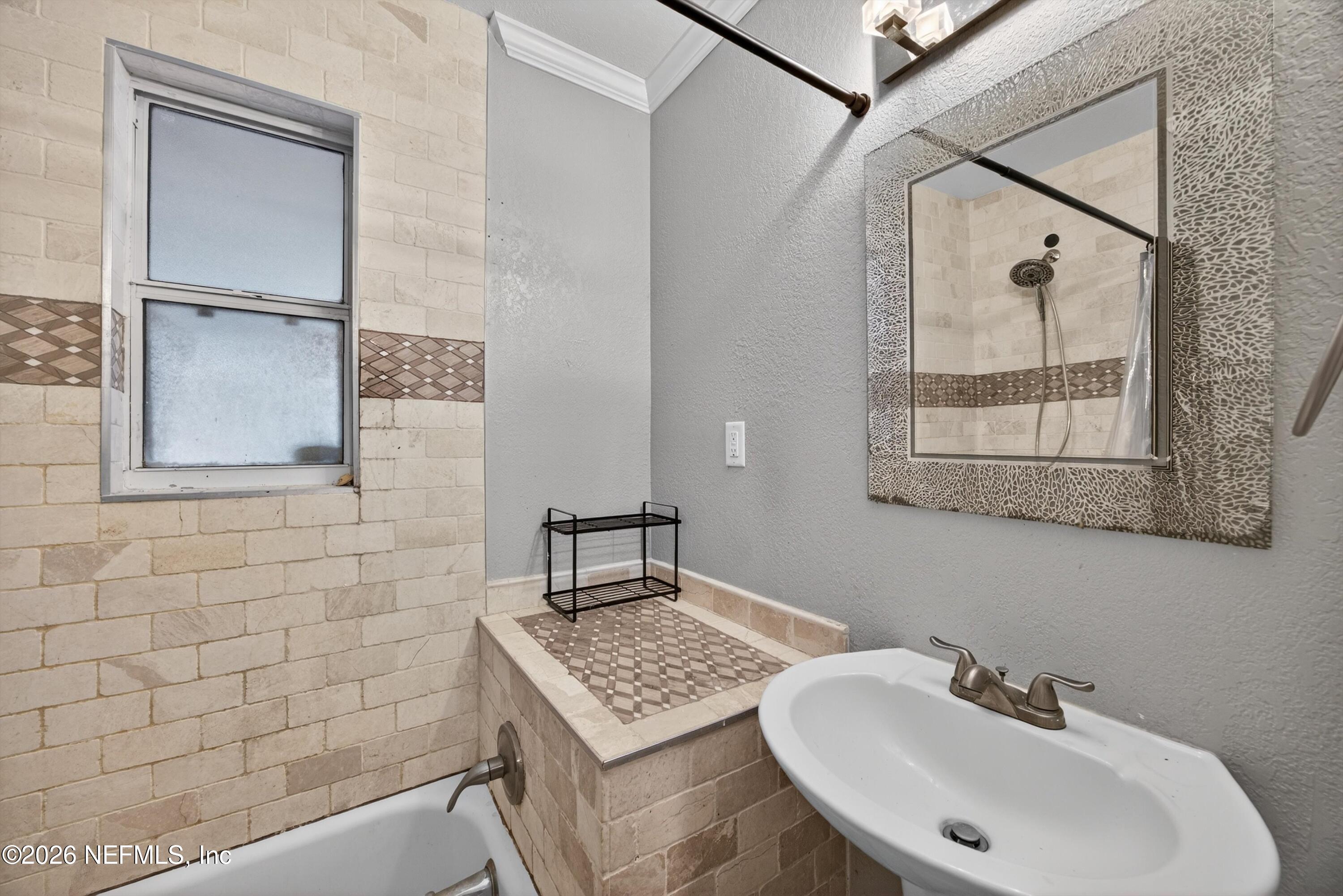 5134 Damascus Road South Jacksonville, FL 32207 - Photo 30 of 41 a bathroom with a sink a mirror and a shower