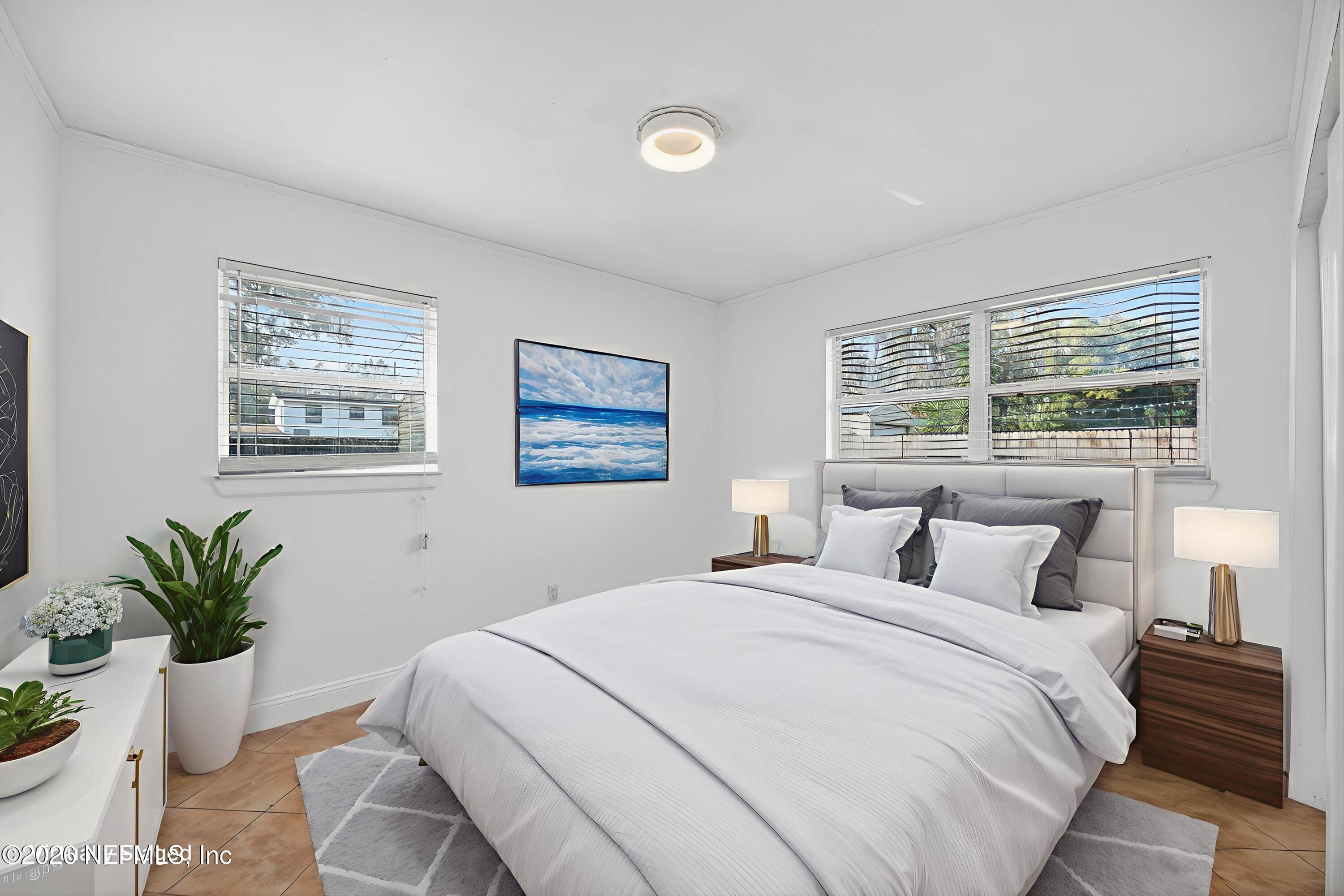 5134 Damascus Road South Jacksonville, FL 32207 - Photo 31 of 41 a bedroom with a large bed and a potted plant