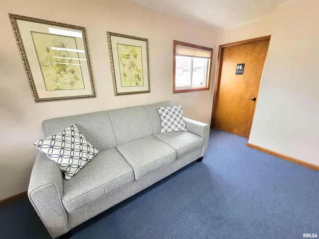 a living room with furniture and a large mirror