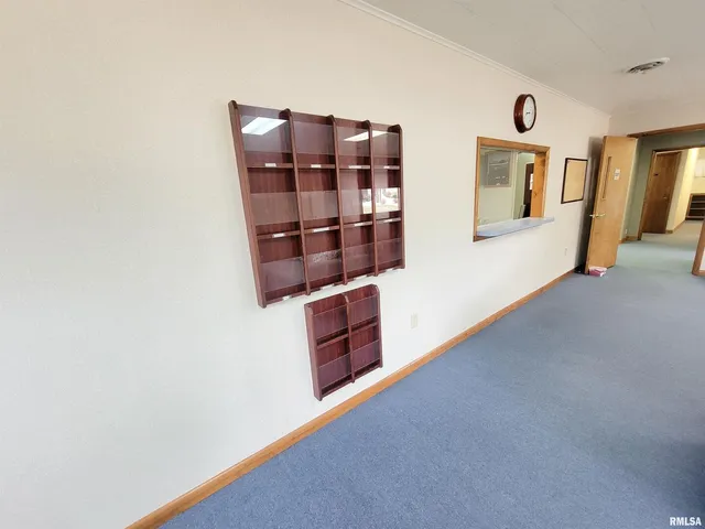 a view of a small space with wooden floor and a window