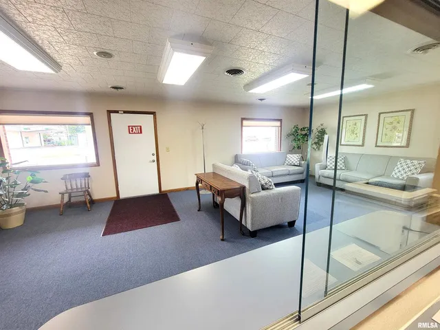 a room with a sink a mirror and cabinets