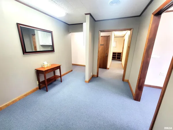 a view of a hallway to rooms