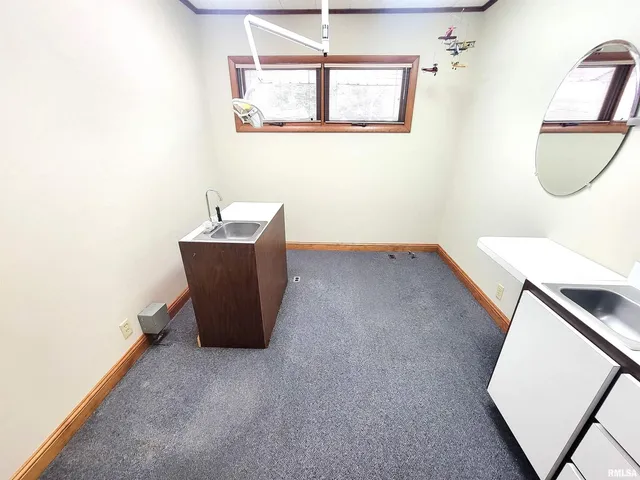 a bathroom with a toilet a sink and a mirror