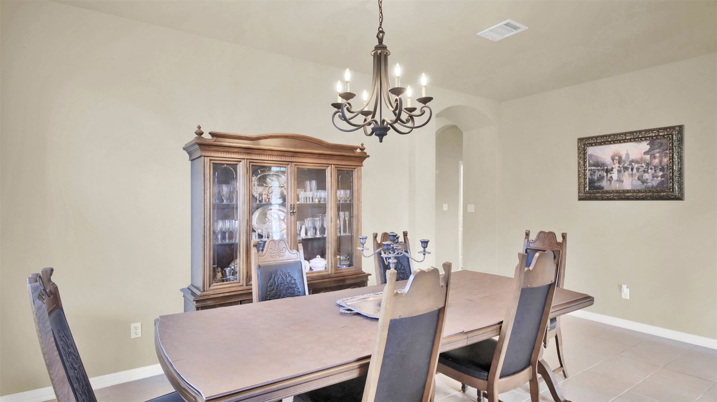 2979 Freemont Street Round Rock, TX 78681 - Photo 11 of 40 Dining room with a chandelier, arched walkways, and light tile patterned floors