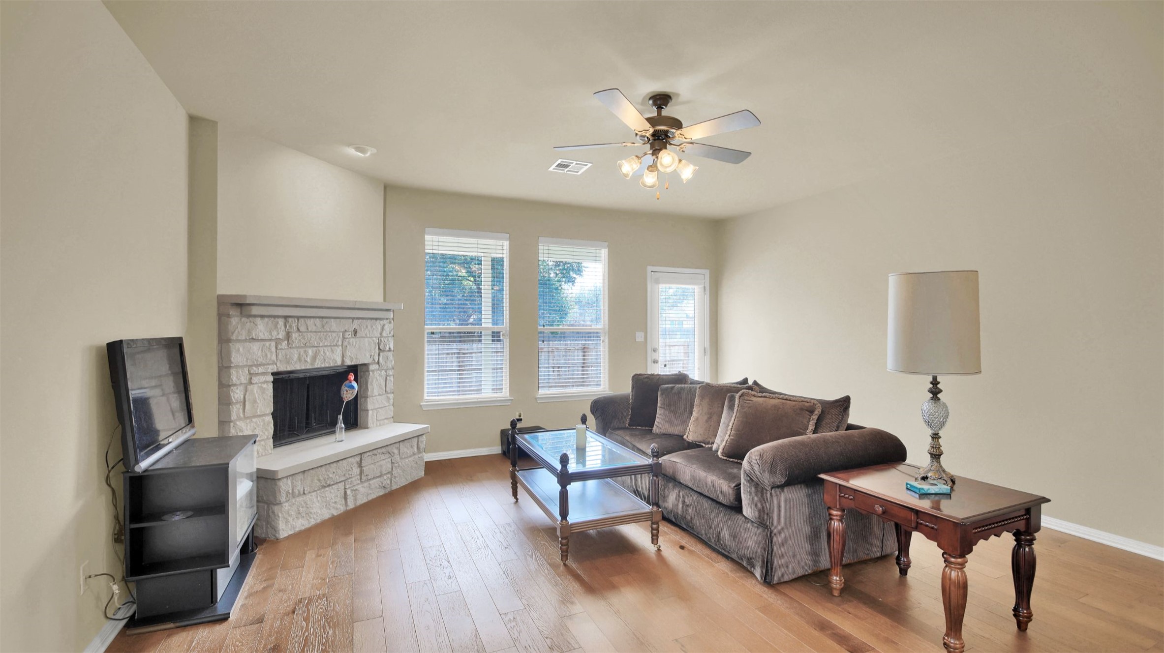2979 Freemont Street Round Rock, TX 78681 - Photo 21 of 40 Living area with light wood-type flooring, a fireplace, and ceiling fan