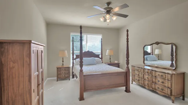 a bedroom with a bed and a window