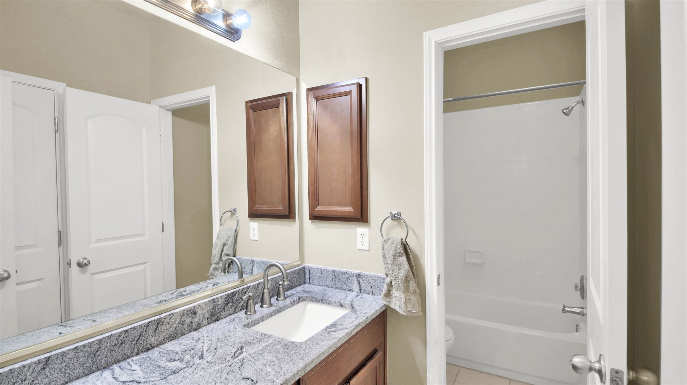 2979 Freemont Street Round Rock, TX 78681 - Photo 30 of 40 Full bath featuring vanity, bathing tub / shower combination, and light tile patterned flooring