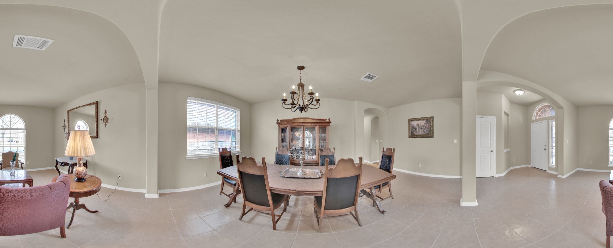 2979 Freemont Street Round Rock, TX 78681 - Photo 33 of 40 Dining space featuring arched walkways, a barrel ceiling, suspended lighting, healthy amount of natural light, and light tile patterned flooring