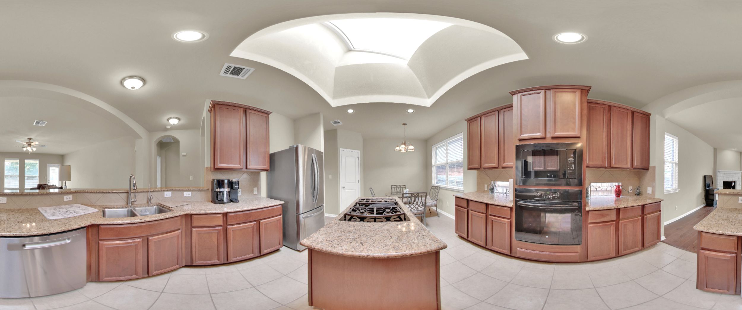 2979 Freemont Street Round Rock, TX 78681 - Photo 38 of 40 Kitchen with pendant lighting, black appliances, light stone countertops, tasteful backsplash, and arched walkways