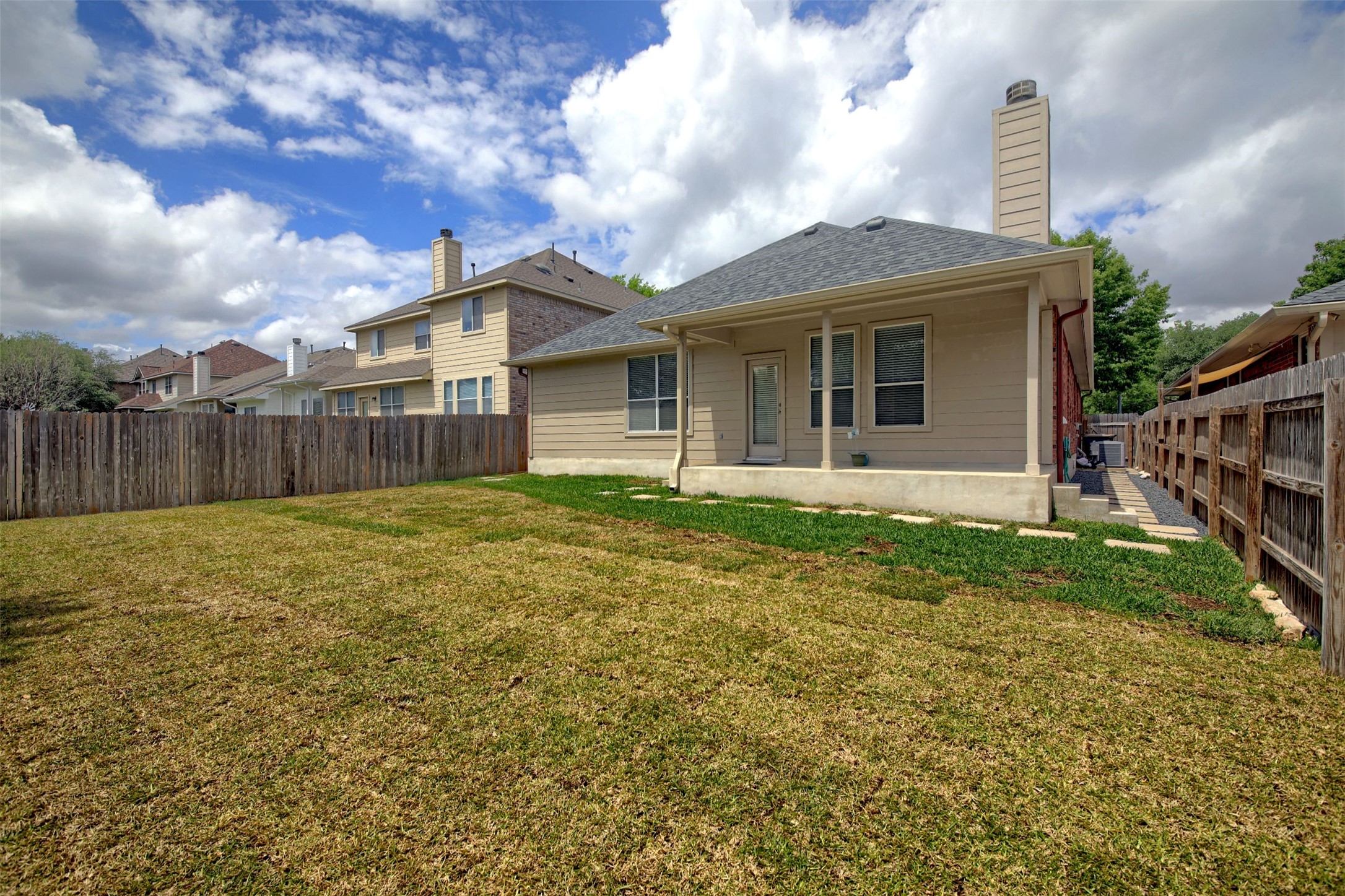 2979 Freemont Street Round Rock, TX 78681 - Photo 38 of 40 The property features a private backyard with a wooden fence and a large covered patio area