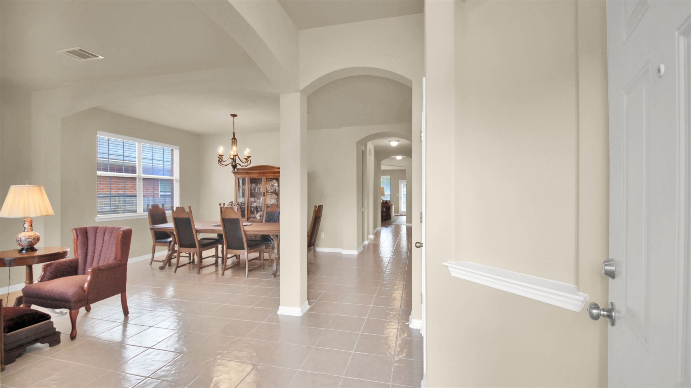 2979 Freemont Street Round Rock, TX 78681 - Photo 5 of 40 Dining area featuring arched walkways, light tile patterned floors, and suspended lighting