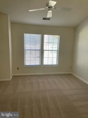 an empty room with a empty space and windows