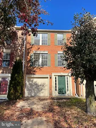 front view of a house with a tree