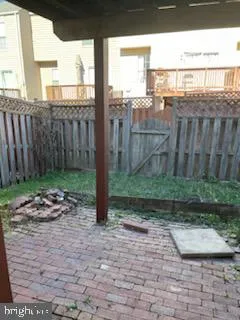 a view of a backyard with chair and wooden fence