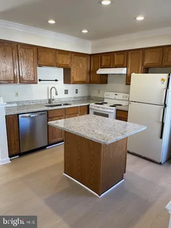 a kitchen with stainless steel appliances granite countertop a stove a sink dishwasher a refrigerator and a oven