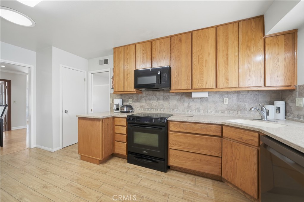 26500 New Bedford Road Menifee, CA 92586 - Photo 13 of 47 a kitchen with stainless steel appliances granite countertop a stove a sink and a refrigerator