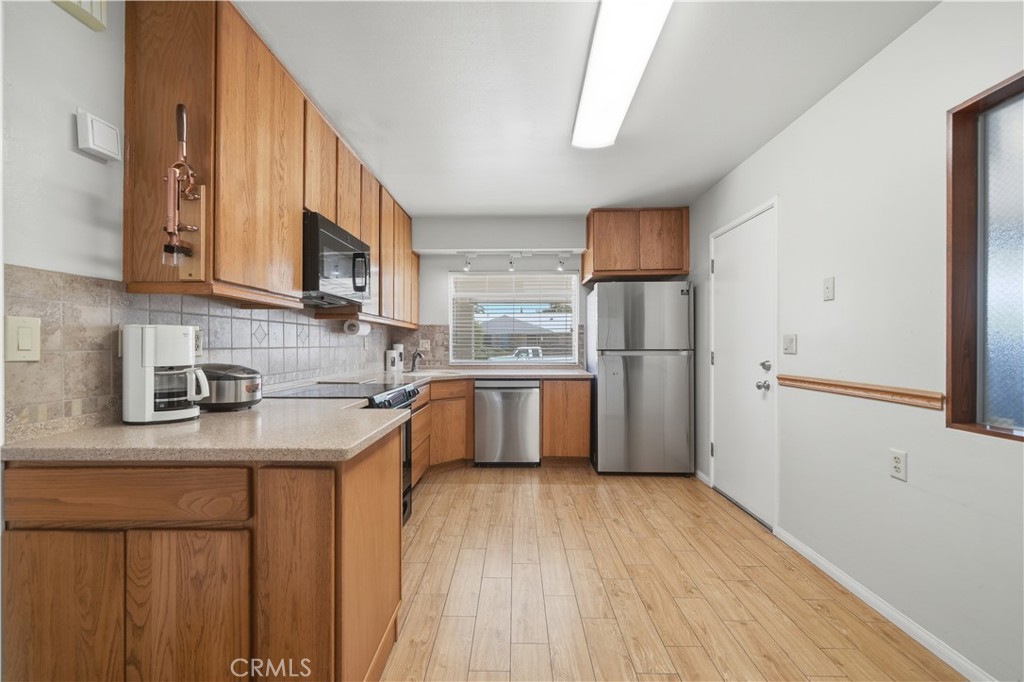 26500 New Bedford Road Menifee, CA 92586 - Photo 14 of 47 a kitchen with stainless steel appliances granite countertop a refrigerator sink and cabinets