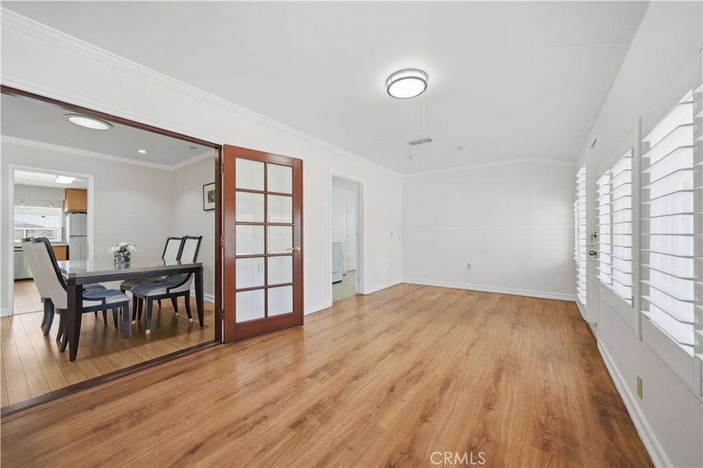 26500 New Bedford Road Menifee, CA 92586 - Photo 16 of 47 an empty room with wooden floor and windows