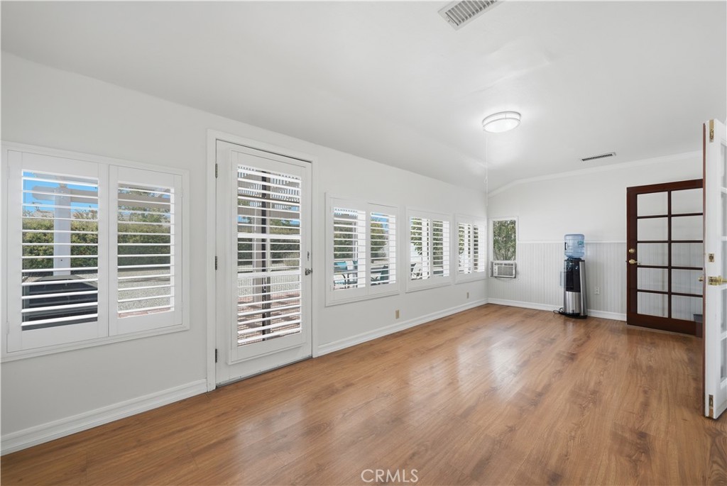 26500 New Bedford Road Menifee, CA 92586 - Photo 18 of 47 a view of an empty room with wooden floor and a window