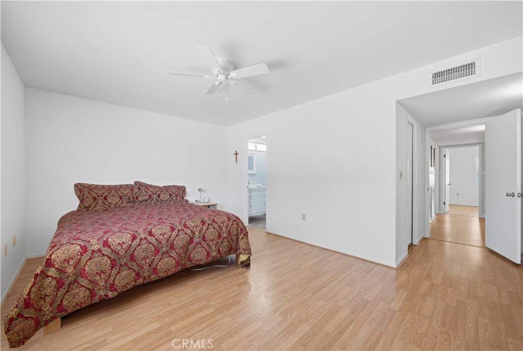 26500 New Bedford Road Menifee, CA 92586 - Photo 22 of 47 a bedroom with a bed and wooden floor