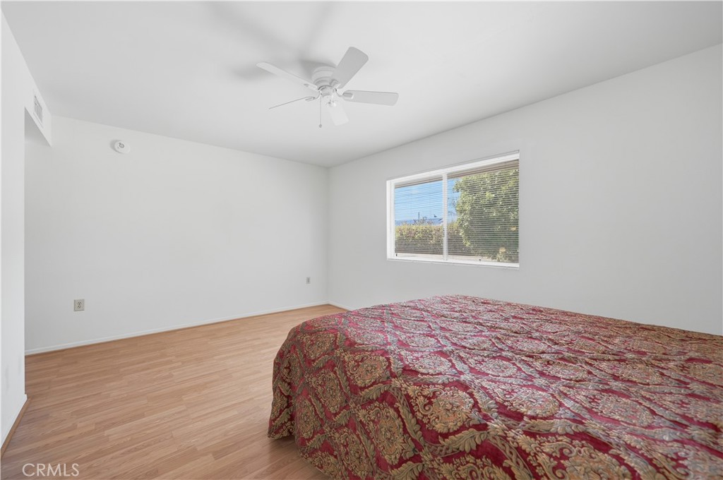 26500 New Bedford Road Menifee, CA 92586 - Photo 23 of 47 a bedroom with a large bed and a window