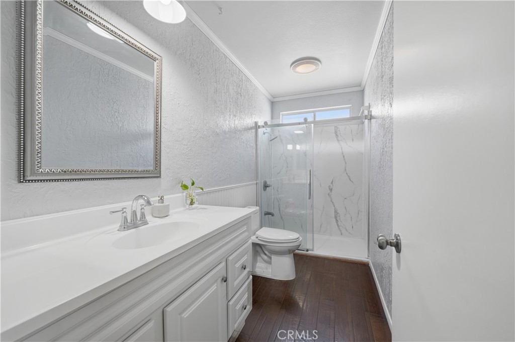 26500 New Bedford Road Menifee, CA 92586 - Photo 26 of 47 a bathroom with a sink a toilet and shower
