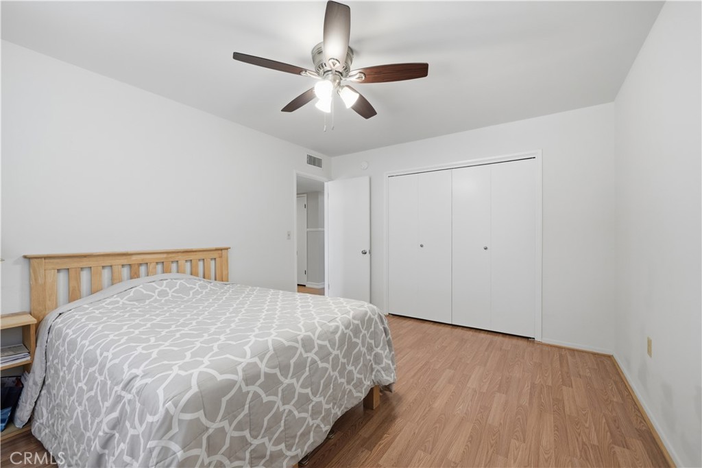 26500 New Bedford Road Menifee, CA 92586 - Photo 28 of 47 a bedroom with a large bed and a chandelier