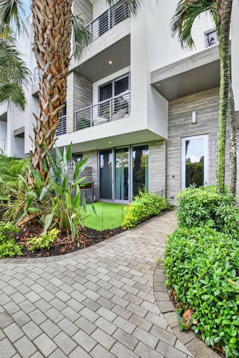 4021 Northwest 18th Way Boca Raton, FL 33431 - Photo 2 of 37 a front view of a house with a garden