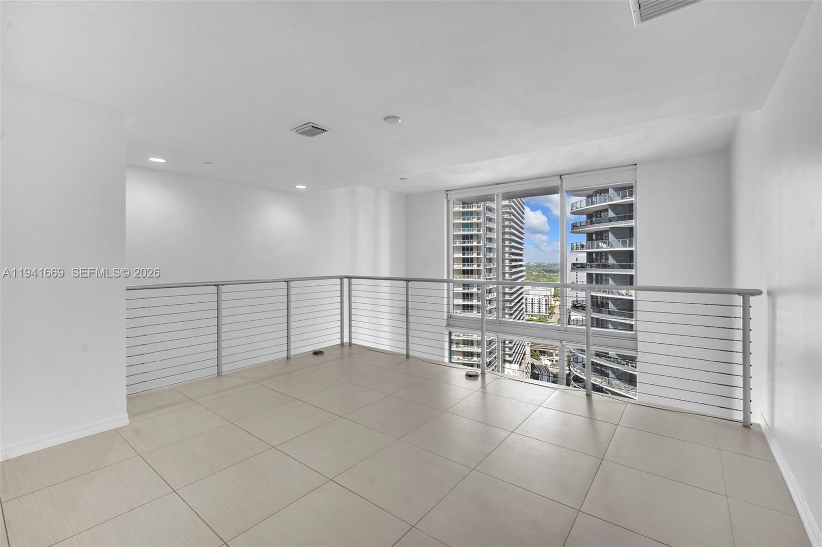 1050 Brickell Avenue, Unit 2418 Miami, FL 33131 - Photo 12 of 25 a view of an empty room with stairs